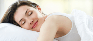 Woman achieving better sleep perimenopause women need - resting peacefully in bed