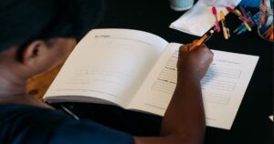 Woman maintaining consistency with business systems using daily planner