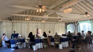 Women leaders participating in a structured live workshop with a facilitator guiding group discussion and learning activities