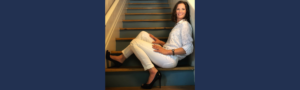 Woman sitting confidently on staircase in heels, symbolizing women leaders investing in themselves and stepping beyond bootstrapping
