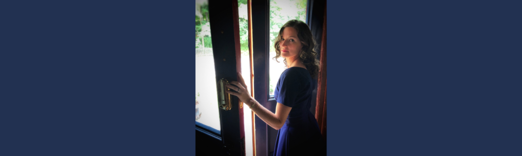 Woman looking through an open door, representing proprioception and leadership