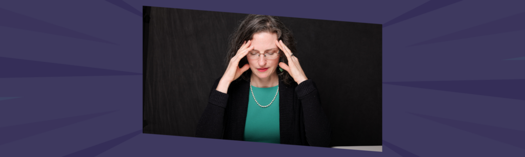 Woman leader experiencing leadership overwhelm at her desk